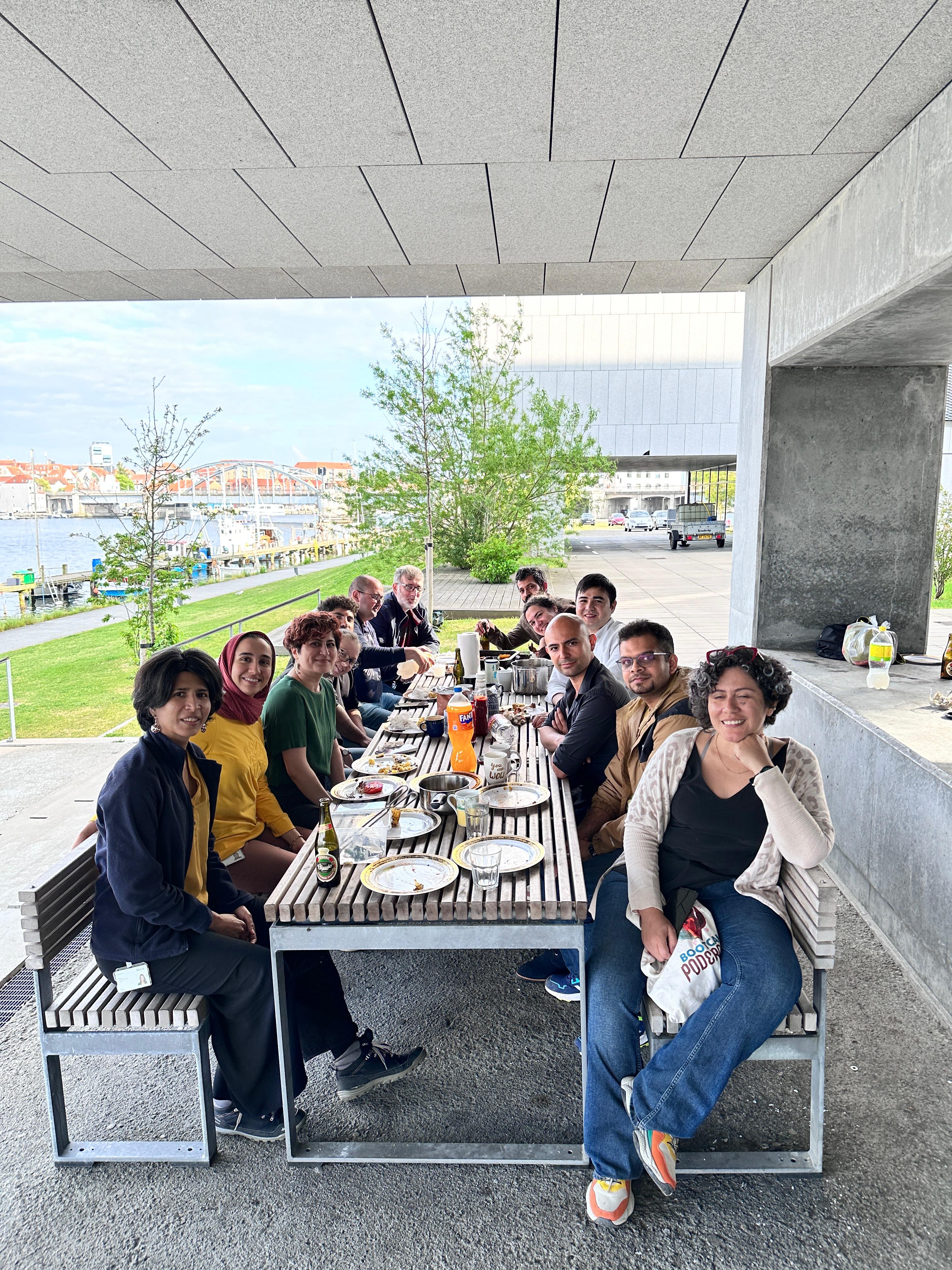 Scholars barbecue gathering beside the campus waterfront